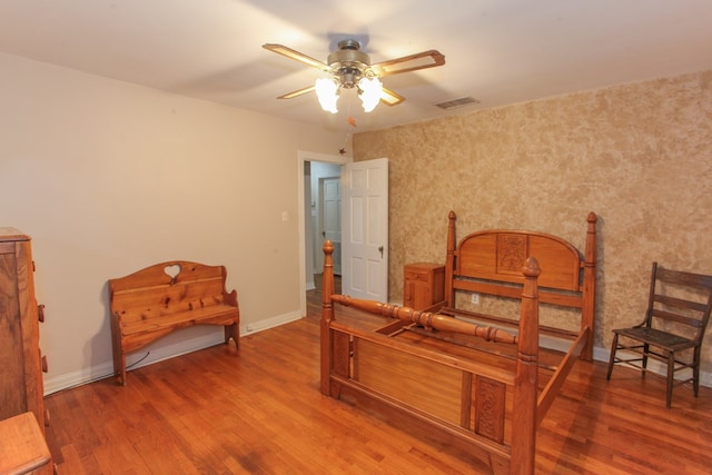 living area featuring ceiling fan and wood-type flooring