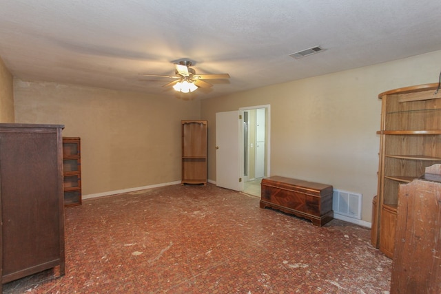 unfurnished living room with a textured ceiling and ceiling fan