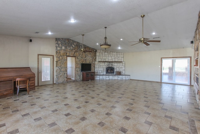 unfurnished living room with ceiling fan, a fireplace, and high vaulted ceiling