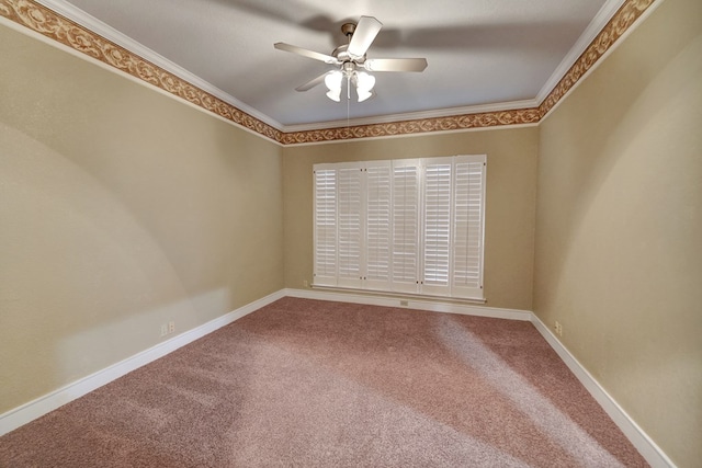 carpeted empty room featuring ornamental molding and ceiling fan