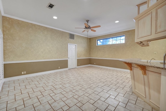 spare room featuring crown molding and ceiling fan