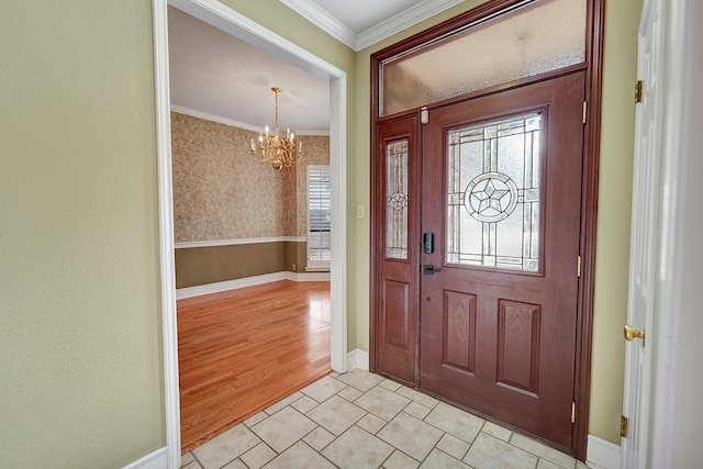 entrance foyer with crown molding and an inviting chandelier