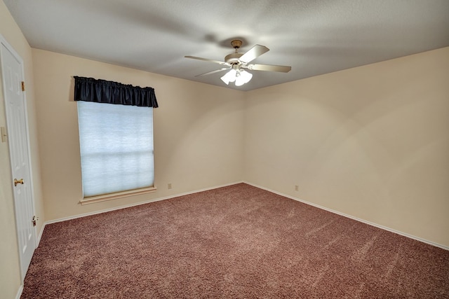 spare room featuring carpet floors and ceiling fan