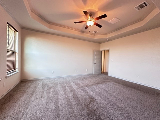 3210 Fordham Ave, Big Spring, TX 79720 - unfurnished room featuring a raised ceiling, ornamental molding, ceiling fan, and carpet