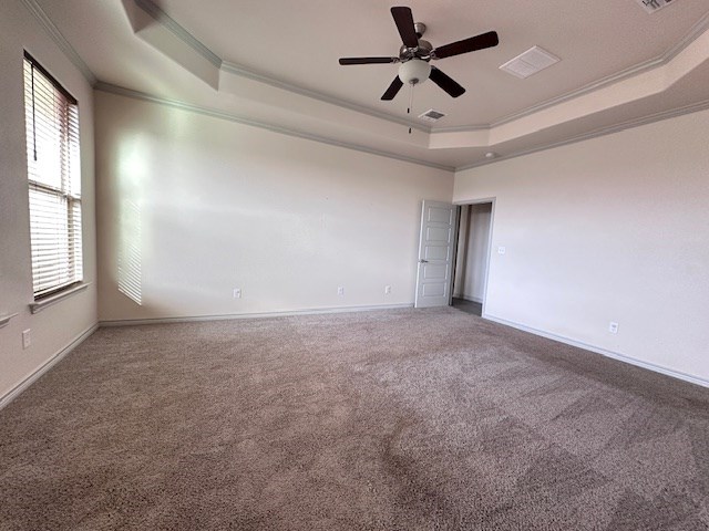 3210 Fordham Ave, Big Spring, TX 79720 - carpeted empty room with a raised ceiling, ornamental molding, healthy amount of natural light, and a ceiling fan