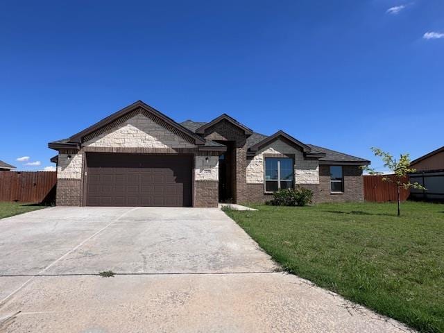 3210 Fordham Ave, Big Spring, TX 79720 - single story home with an attached garage, driveway, and brick siding