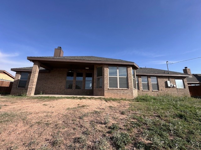 3210 Fordham Ave, Big Spring, TX 79720 - back of property with a chimney and brick siding