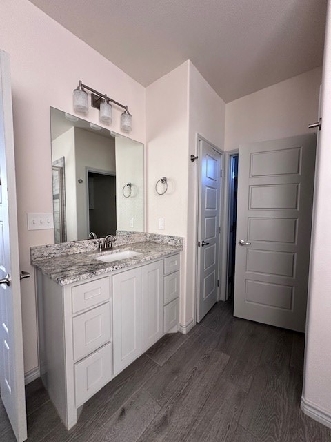 3210 Fordham Ave, Big Spring, TX 79720 - bathroom featuring wood finished floors and vanity