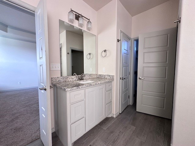 3210 Fordham Ave, Big Spring, TX 79720 - bathroom featuring vanity and wood finished floors