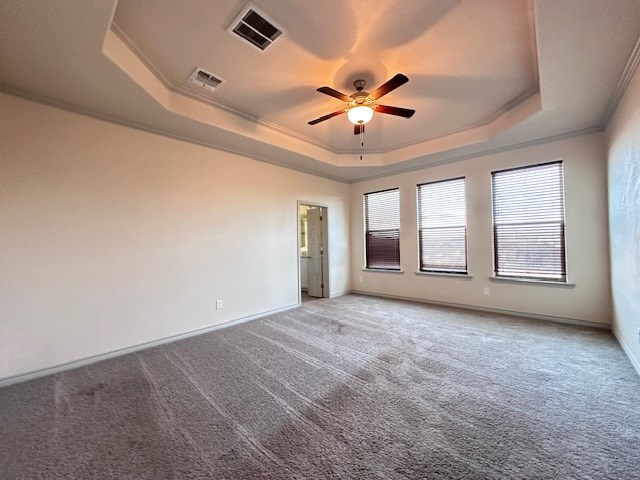 3210 Fordham Ave, Big Spring, TX 79720 - carpeted spare room featuring a tray ceiling, ceiling fan, and ornamental molding