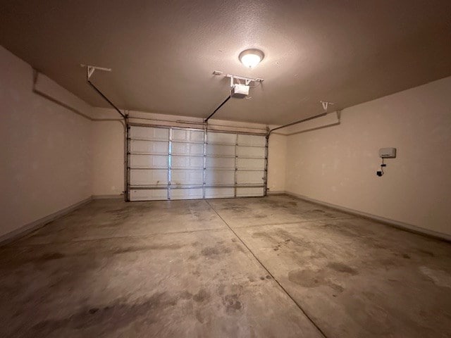 3210 Fordham Ave, Big Spring, TX 79720 - garage featuring a garage door opener and baseboards
