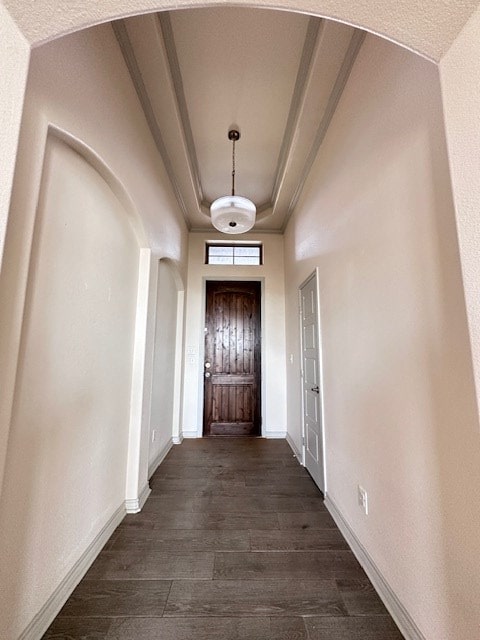 3210 Fordham Ave, Big Spring, TX 79720 - entryway featuring arched walkways, dark wood-style flooring, a tray ceiling, and crown molding