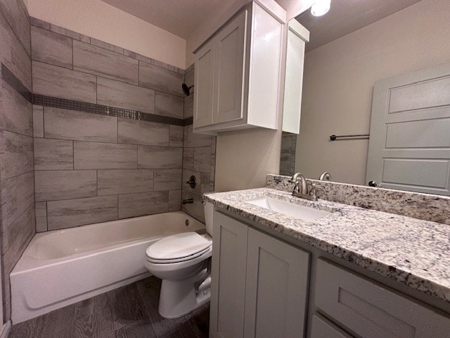 3210 Fordham Ave, Big Spring, TX 79720 - full bath with vanity, wood finished floors, and bathing tub / shower combination