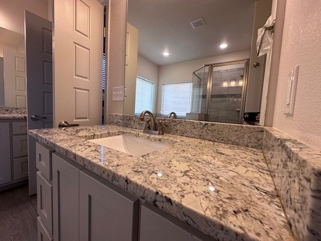 3210 Fordham Ave, Big Spring, TX 79720 - full bath with a shower stall, vanity, wood finished floors, and recessed lighting