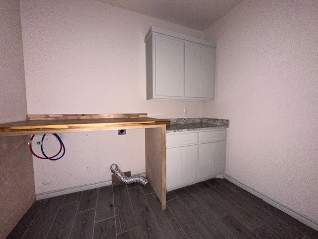 3210 Fordham Ave, Big Spring, TX 79720 - laundry room featuring cabinet space, washer hookup, and dark wood finished floors