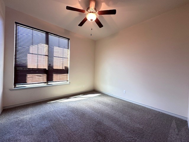 3210 Fordham Ave, Big Spring, TX 79720 - carpeted empty room featuring ceiling fan and baseboards