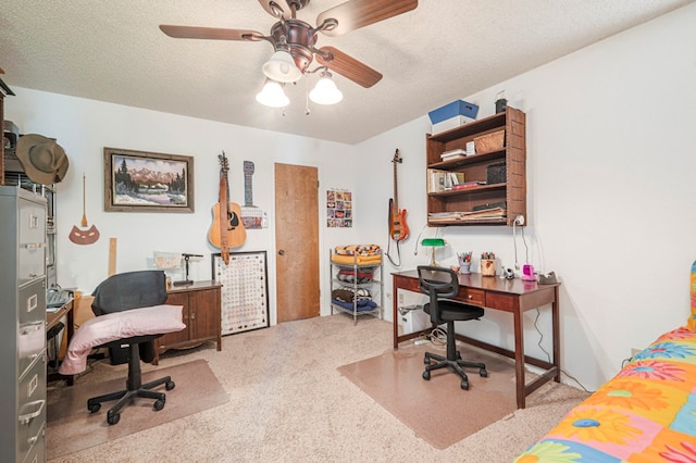 home office with a textured ceiling, light carpet, and a ceiling fan