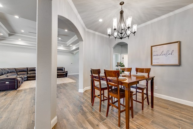 1602 S County Rd 1069, Midland, TX 79706 - dining room featuring arched walkways, crown molding, baseboards, wood finished floors, and a chandelier