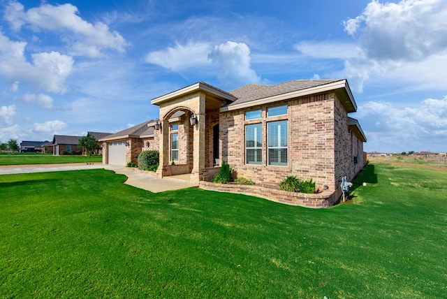 1602 S County Rd 1069, Midland, TX 79706 - view of front of property with brick siding, a front yard, concrete driveway, and a garage