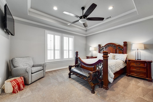 bedroom featuring visible vents, crown molding, and a tray ceiling