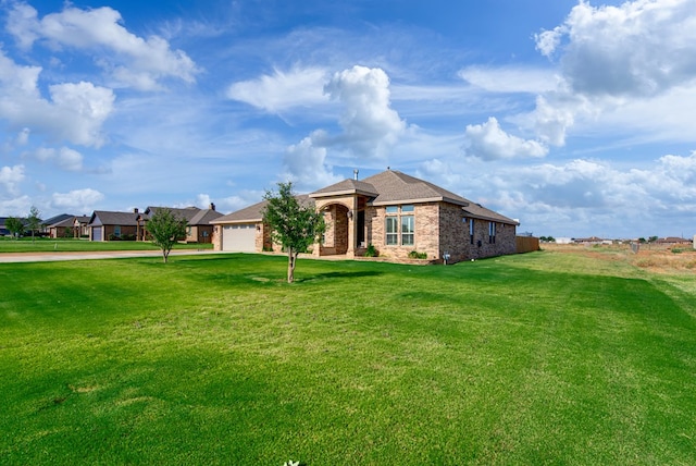 1602 S County Rd 1069, Midland, TX 79706 - ranch-style home with an attached garage, brick siding, a front yard, driveway, and roof with shingles