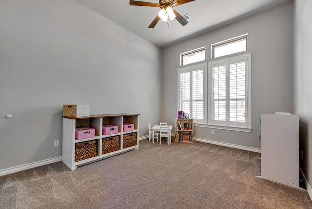 game room featuring vaulted ceiling, a ceiling fan, baseboards, and carpet floors