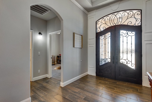 1602 S County Rd 1069, Midland, TX 79706 - foyer featuring arched walkways, french doors, dark wood-style flooring, ornamental molding, and baseboards