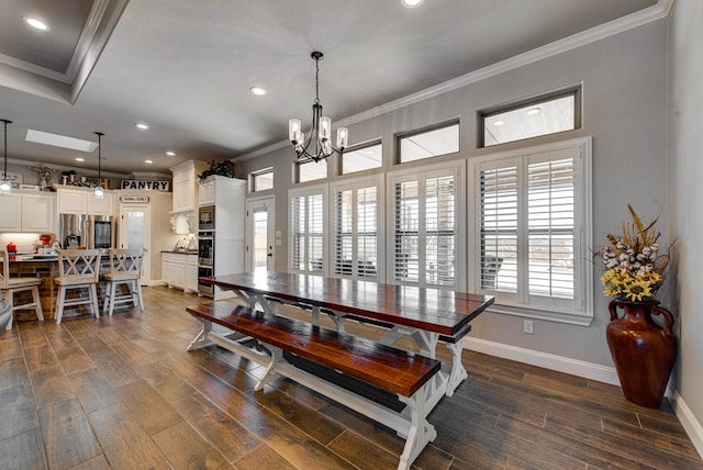 dining room featuring dark wood-type flooring, baseboards, ornamental molding, recessed lighting, and a notable chandelier