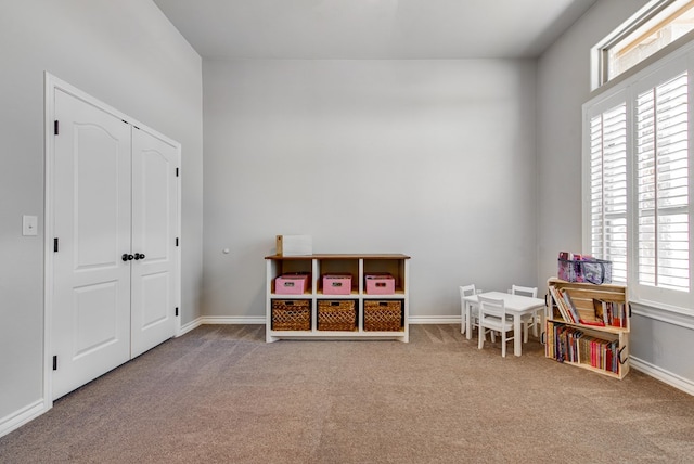 playroom with baseboards and carpet floors