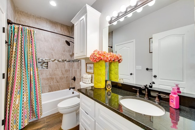 bathroom featuring vanity, toilet, wood finished floors, and shower / bath combo with shower curtain