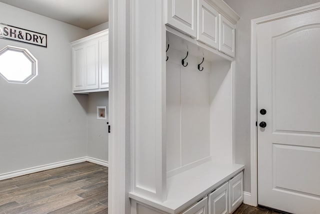 mudroom featuring baseboards and dark wood-style flooring