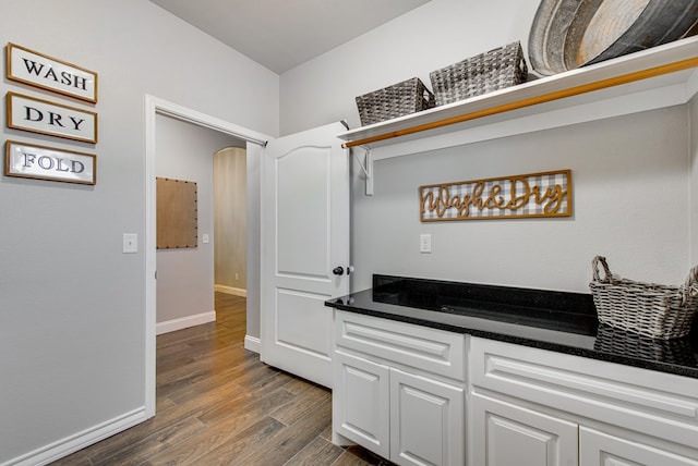 interior space with dark wood-style floors and baseboards