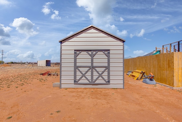 view of shed featuring fence