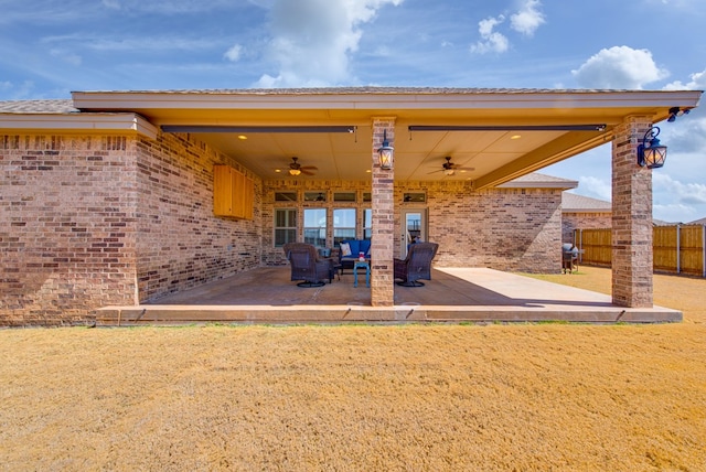 view of patio with ceiling fan and fence