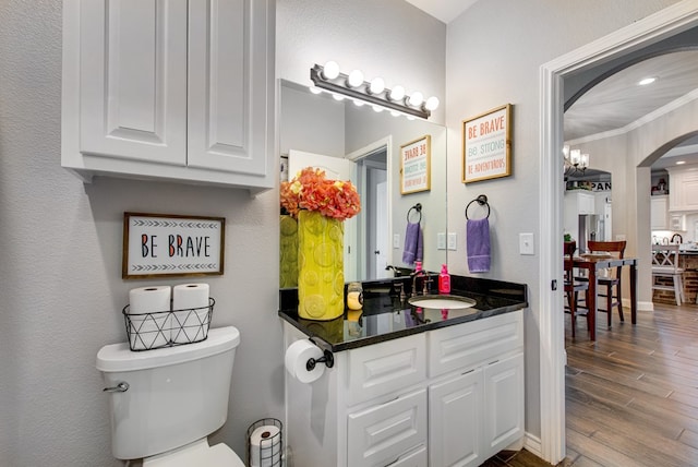 1602 S County Rd 1069, Midland, TX 79706 - half bath featuring toilet, wood finished floors, and vanity