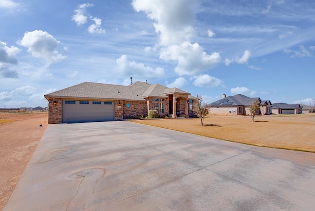 single story home with stone siding, concrete driveway, a garage, and a front yard