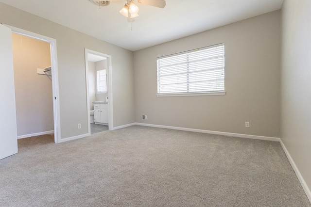 3319 Maxwell Dr, Midland, TX 79705 - unfurnished bedroom featuring a spacious closet, carpet flooring, connected bathroom, a closet, and ceiling fan