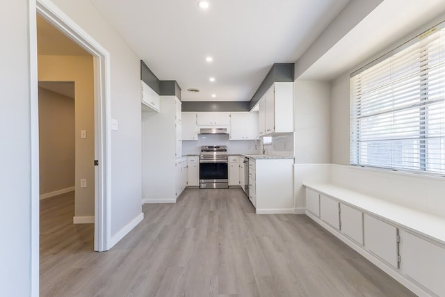3319 Maxwell Dr, Midland, TX 79705 - kitchen featuring stainless steel range with electric stovetop, under cabinet range hood, light wood-style floors, light countertops, and recessed lighting