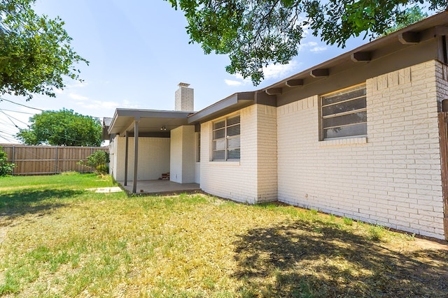 3319 Maxwell Dr, Midland, TX 79705 - back of house with a chimney, a patio area, and brick siding