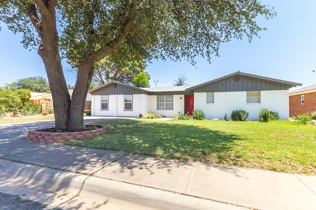 3319 Maxwell Dr, Midland, TX 79705 - single story home featuring a front lawn, brick siding, and board and batten siding