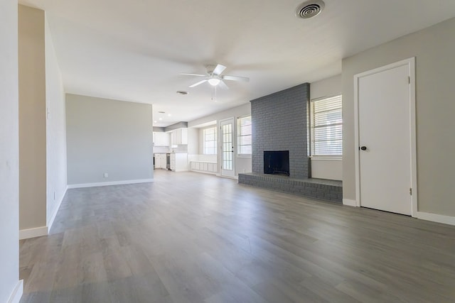 3319 Maxwell Dr, Midland, TX 79705 - unfurnished living room featuring ceiling fan, a brick fireplace, and light wood finished floors