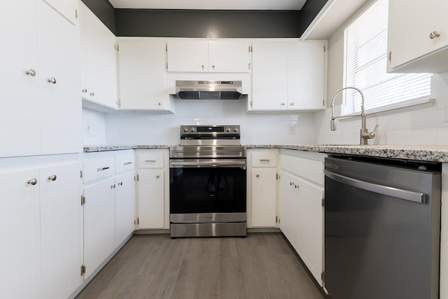 3319 Maxwell Dr, Midland, TX 79705 - kitchen with stainless steel appliances, exhaust hood, wood finished floors, and tasteful backsplash