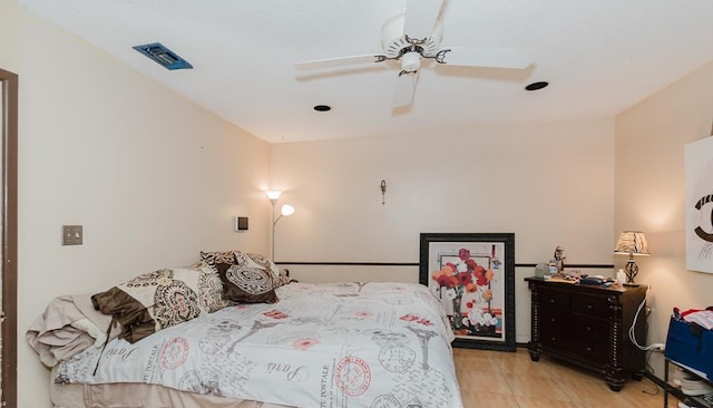 bedroom with ceiling fan, visible vents, and light tile patterned flooring