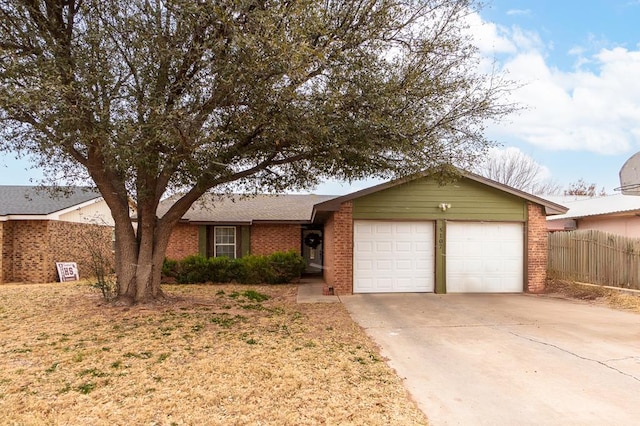 single story home featuring a garage, driveway, fence, and brick siding