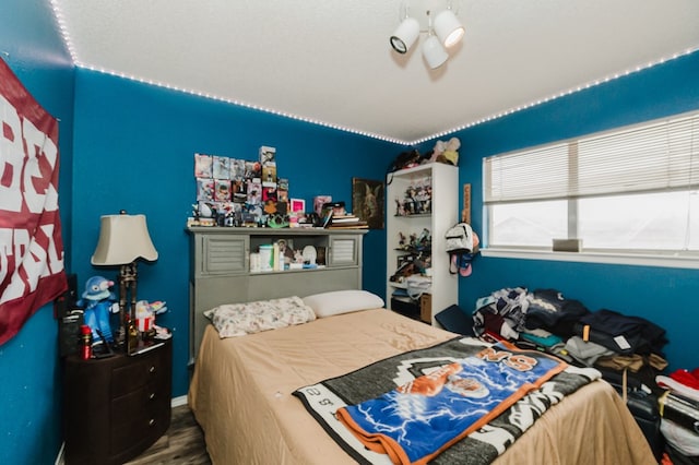 bedroom with wood finished floors