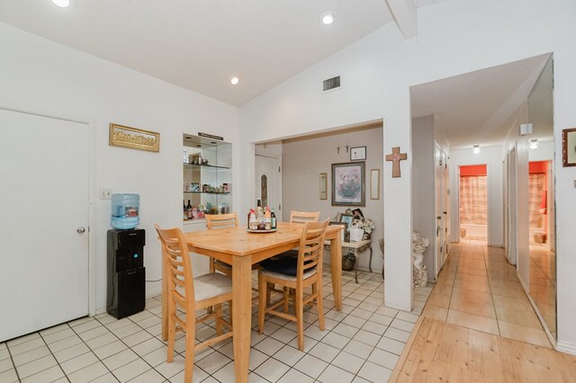 dining space featuring vaulted ceiling with beams, light tile patterned floors, visible vents, and recessed lighting