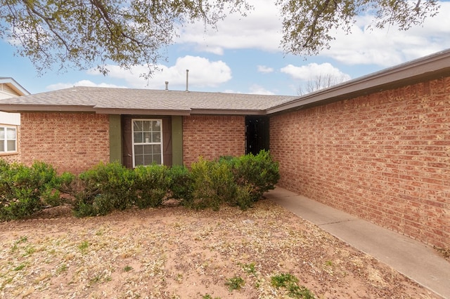 view of side of property featuring brick siding