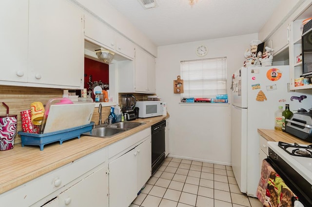 kitchen with black dishwasher, white cabinets, and white microwave