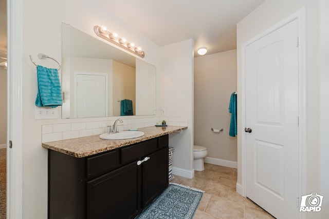 bathroom with tile patterned floors, vanity, tasteful backsplash, and toilet