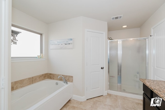 bathroom featuring tile patterned floors, vanity, and plus walk in shower